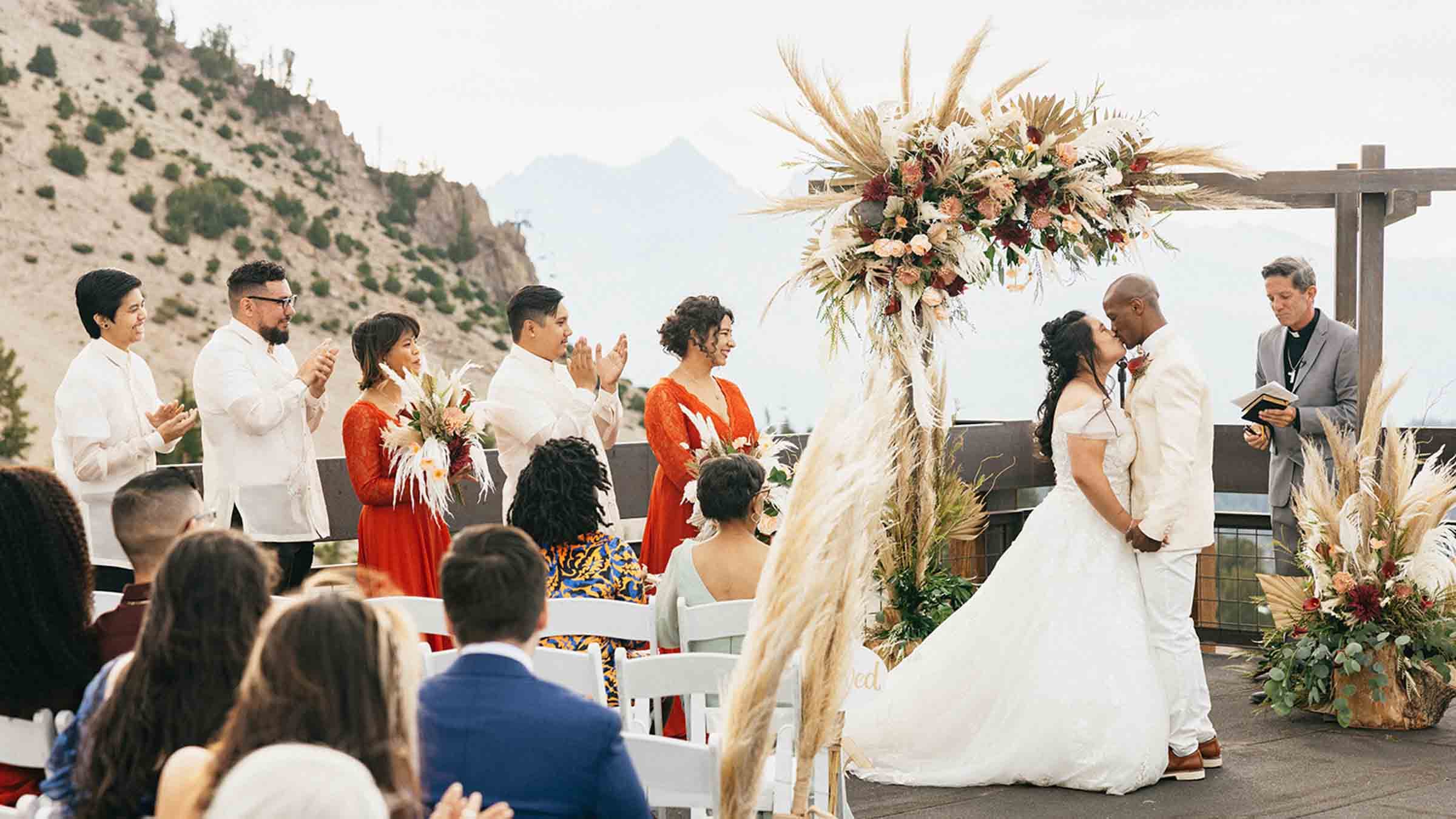A romantic wedding ceremony held at McCoy Station on Monmouth Mountain showcasing breathtaking mountain views.