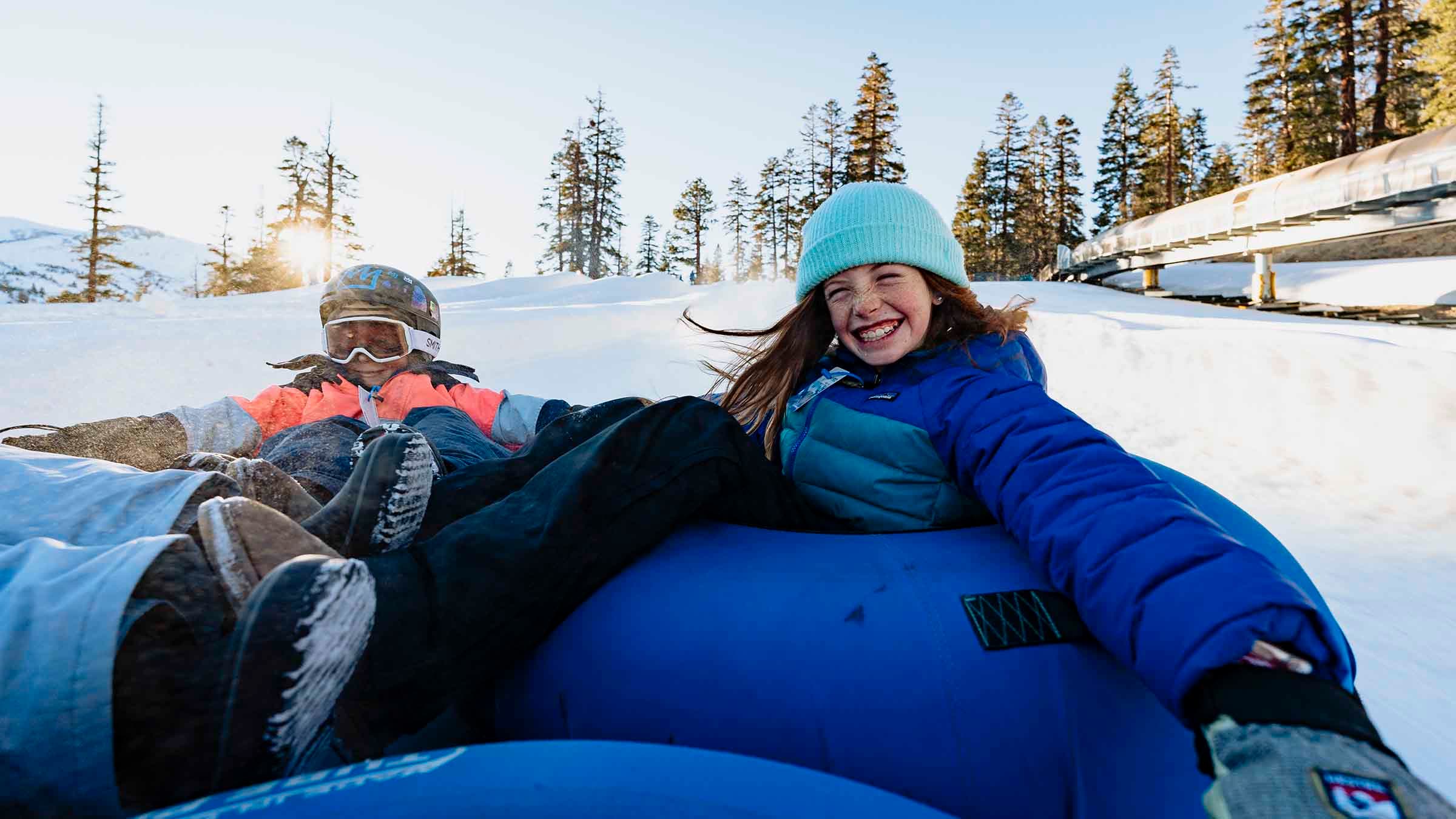 Two kids tubing at Woolly's Adventure Summit