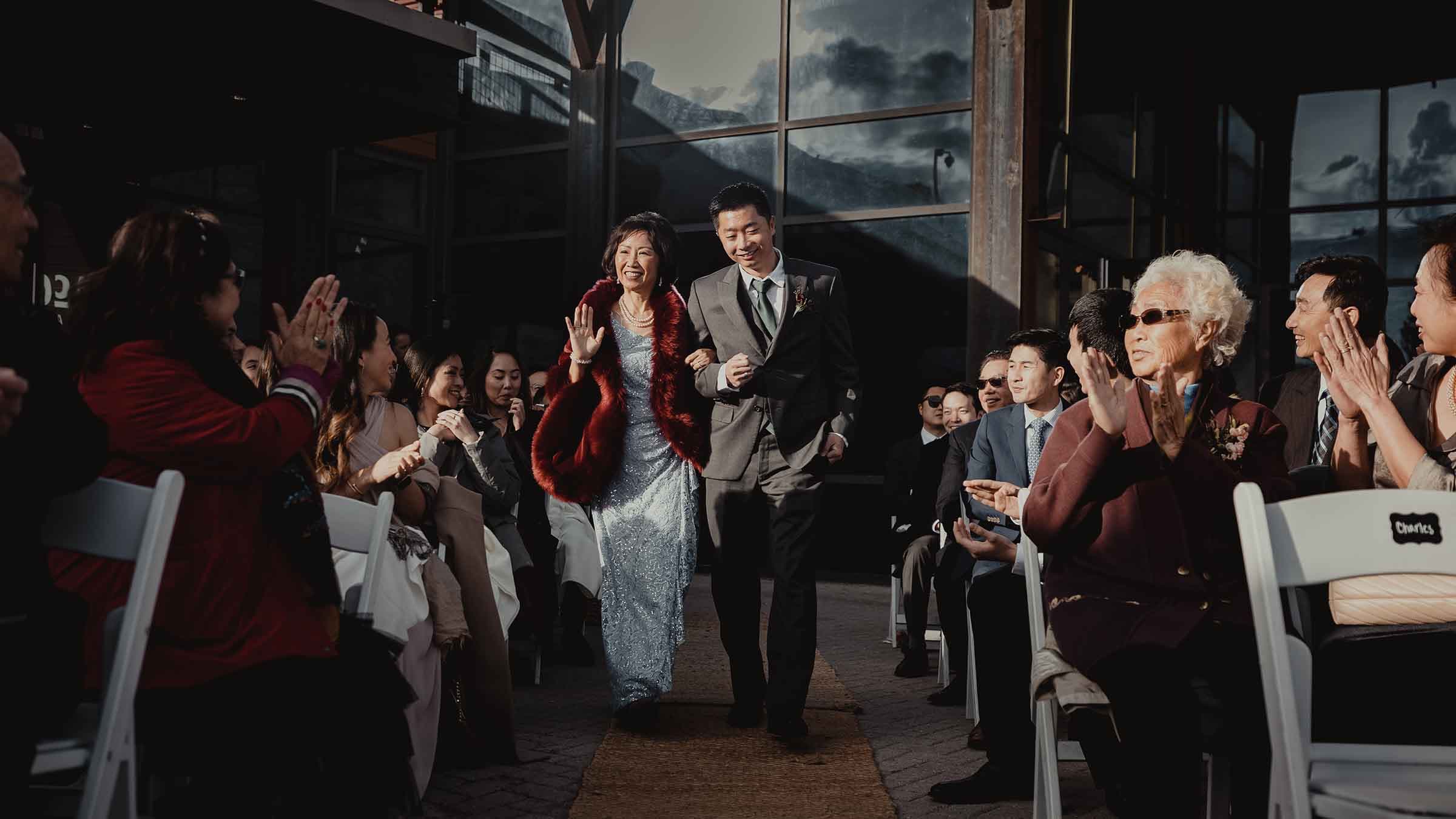A couple walk down the ale from the main entrance of McCoy Station wedding venue